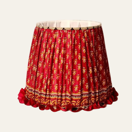 Red lampshade with gold patterns on a beige background