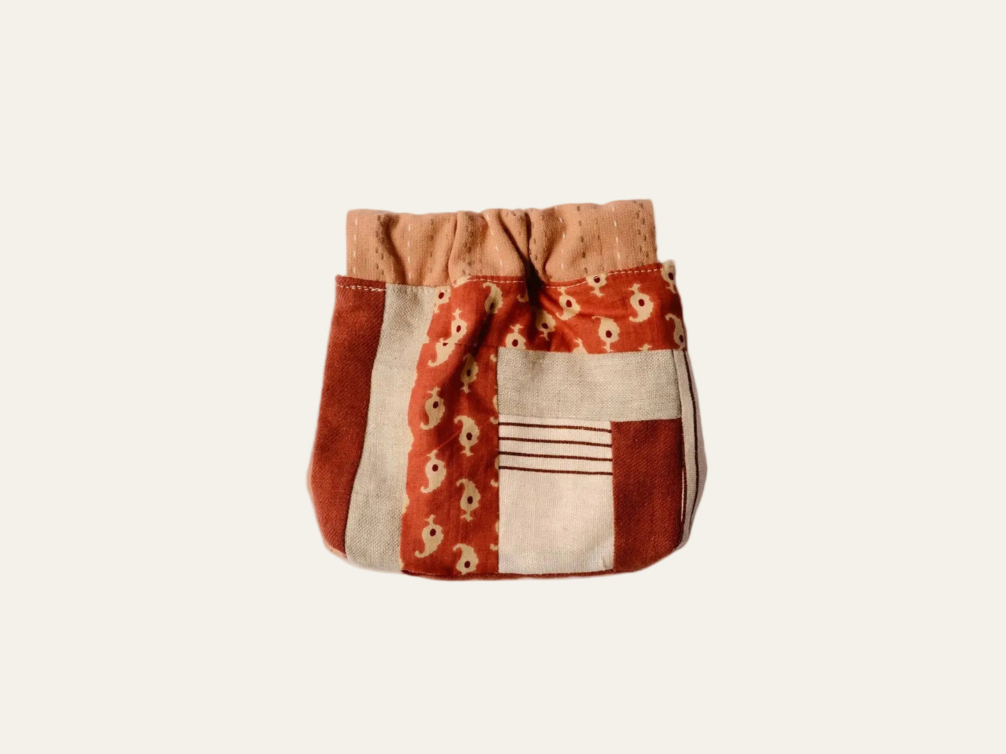 Patchwork pouch with floral patterns on a beige background