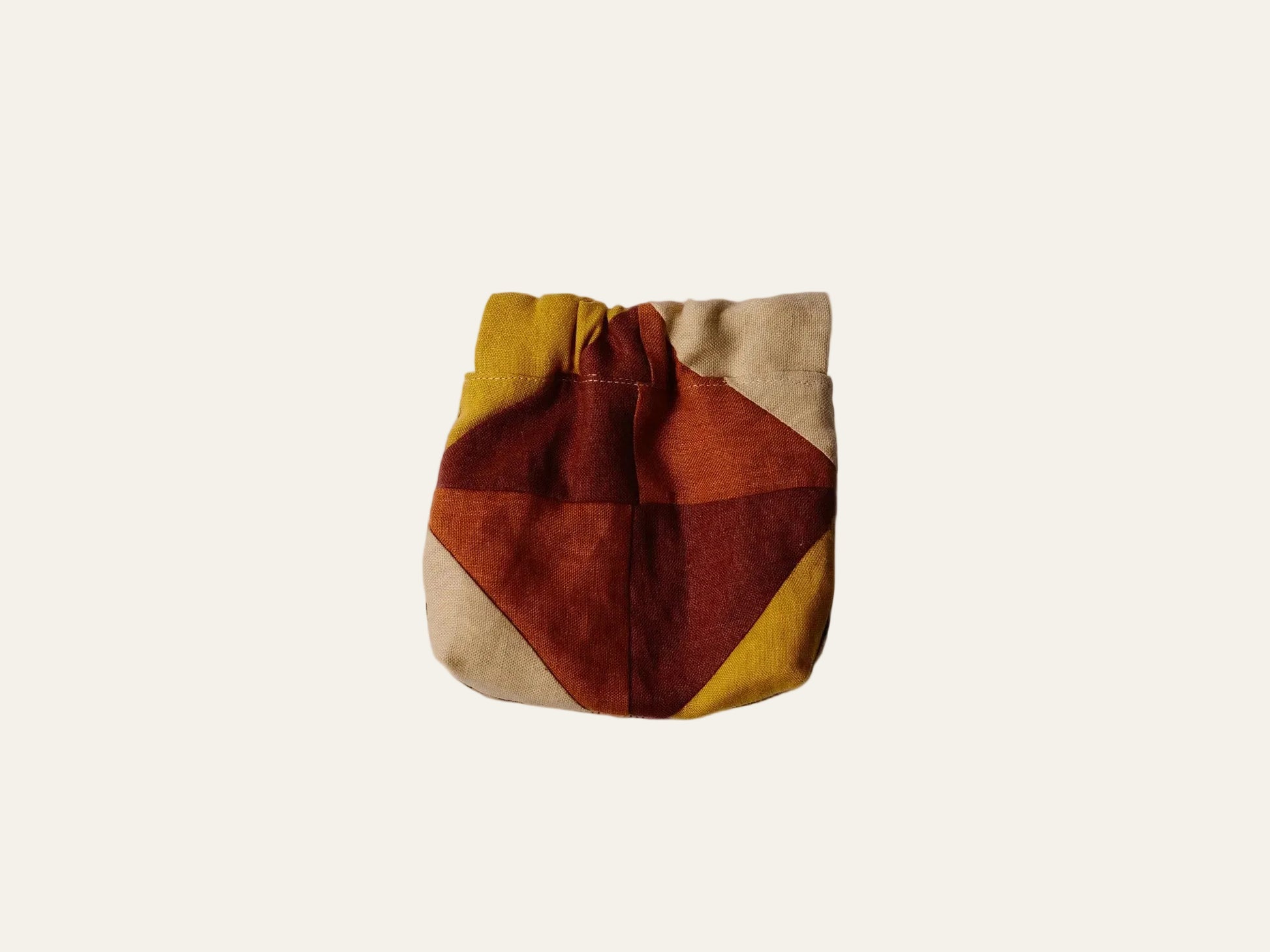 Fabric pouch with geometric pattern on a beige background